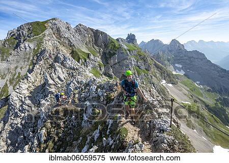 Mountaineer on a ridge on a secured fixed rope route, Mittenwalder Höhenweg, Karwendel Mountains, Mittenwald, Bavaria, Germany, Europe View Large Photo Image Stock Photography - Mountaineer on a ridge on a secured fixed rope route, Mittenwalder Höhenweg, Karwendel Mountains, Mittenwald, Bavaria, Germany, Europe. Fotosearch