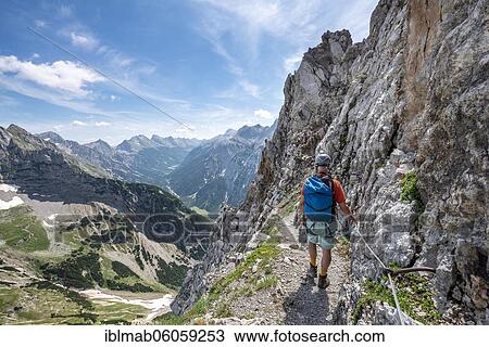 Mountaineer on a secured via ferrata, Mittenwalder Höhenweg, view of the Karwendel valley, Karwendel mountains, Mittenwald, Bavaria, Germany, Europe View Large Photo Image Stock Image - Mountaineer on a secured via ferrata, Mittenwalder Höhenweg, view of the Karwendel valley, Karwendel mountains, Mittenwald, Bavaria, Germany, Europe. Fotosearch