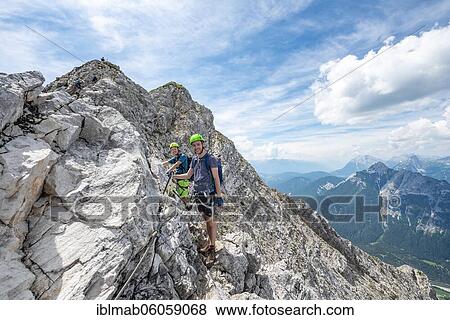 Mountaineers climbing on a secured fixed rope route, Mittenwalder Höhenweg, Karwendel Mountains, Mittenwald, Bavaria, Germany, Europe View Large Photo Image Stock Photo - Mountaineers climbing on a secured fixed rope route, Mittenwalder Höhenweg, Karwendel Mountains, Mittenwald, Bavaria, Germany, Europe. Fotosearch
