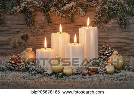 Stock Photography - Natural advent decoration with 4 burning candles. Fotosearch