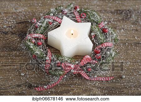 Stock Photograph - Natural advent decoration with star-shaped candle. Fotosearch