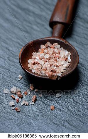 Stock Photography - Natural salt in wooden spoon. Fotosearch