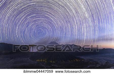 Stock Photo - Night shot with stars, time exposure, Startrails volcanic landscape, smoking active volcano Gunung Bromo, front Mount Batok, behind Mt. Kursi, Mt. Gunung Semeru, Bromo Tengger Semeru National Park, Java, Indonesia, Asia. Fotosearch