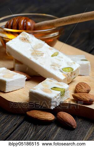Stock Photography - Nougat de Montelimar with almonds and honey. Fotosearch