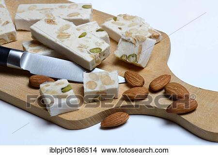 Nougat de Montelimar with knife View Large Photo Image Picture - Nougat de Montelimar with knife. Fotosearch
