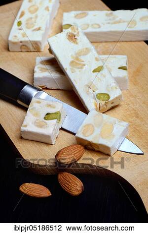Stock Image - Nougat de Montelimar with knife. Fotosearch