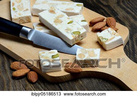 Nougat de Montelimar with knife View Large Photo Image Stock Image - Nougat de Montelimar with knife. Fotosearch