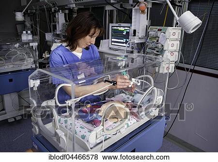 Nurse at incubator with newborn baby, neonatal unit, Altona Children's Hospital, Hamburg, Germany, Europe View Large Photo Image Stock Photo - Nurse at incubator with newborn baby, neonatal unit, Altona Children's Hospital, Hamburg, Germany, Europe. Fotosearch