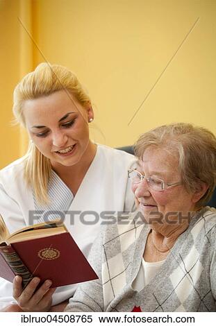 Nurse reading a book to a Senior, Germany, Europe View Large Photo Image Stock Photography - Nurse reading a book to a Senior, Germany, Europe. Fotosearch