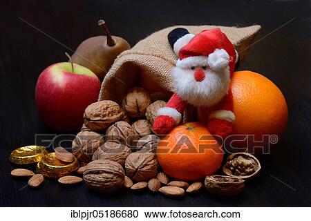 Nuts and fruits for St. Nicholas Day, almonds, apples, pears, orange, tangerine, gold coins, chocolate coins View Large Photo Image Stock Image - Nuts and fruits for St. Nicholas Day, almonds, apples, pears, orange, tangerine, gold coins, chocolate coins. Fotosearch