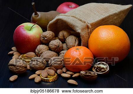 Nuts and fruits for St. Nicholas Day, almonds, apples, pears, orange, tangerine, gold coins, chocolate coins View Large Photo Image Stock Photo - Nuts and fruits for St. Nicholas Day, almonds, apples, pears, orange, tangerine, gold coins, chocolate coins. Fotosearch