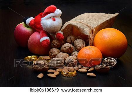 Nuts and fruits for St. Nicholas Day, almonds, apples, pears, orange, tangerine, gold coins, chocolate coins View Large Photo Image Stock Photo - Nuts and fruits for St. Nicholas Day, almonds, apples, pears, orange, tangerine, gold coins, chocolate coins. Fotosearch