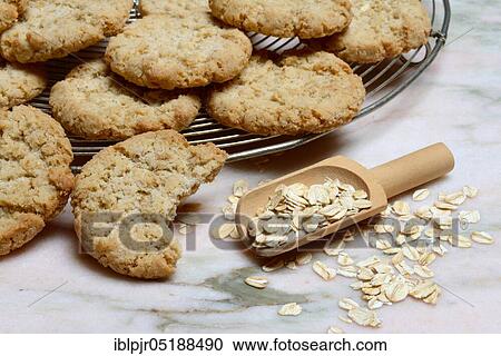 Stock Image - Oatmeal biscuits, oatmeal in scoop, oatmeal cookies, oatmeal biscuits. Fotosearch
