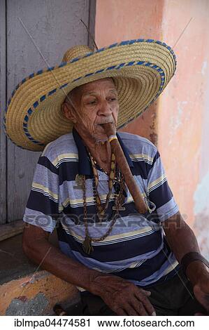 Stock Image - Old man smoking cigar, Camagueey, Cuba, Central America. Fotosearch