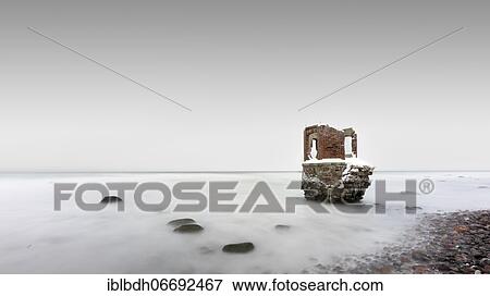 Stock Photo - Old tide gauge house on the beach near Kap Arkona on the German island of Rügen, Mecklenburg-Vorpommern, Germany, Europe. Fotosearch