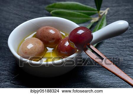 Olive oil and olives in bowls, Amphisis olives, Greek olives from Amphissa, Greece, Europe View Large Photo Image Picture - Olive oil and olives in bowls, Amphisis olives, Greek olives from Amphissa, Greece, Europe. Fotosearch
