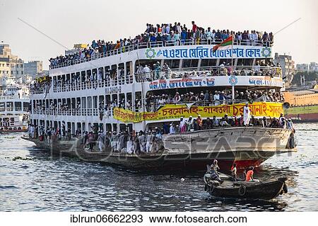 Stock Image - Overloaded passenger ferry with pilgrims on the Dhaka river, Port of Dhaka, Dhaka, Bangladesh, Asia. Fotosearch