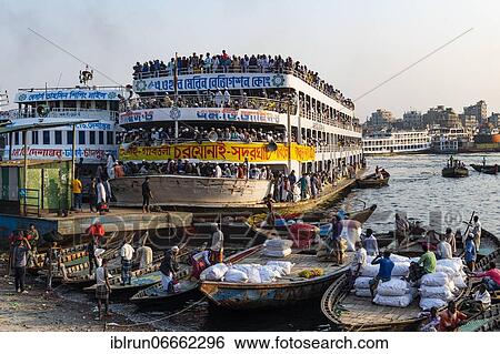 Stock Photograph - Overloaded passenger ferry with pilgrims on the Dhaka river, Port of Dhaka, Dhaka, Bangladesh, Asia. Fotosearch