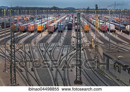 Parked freight cars on tracks at dusk, marshalling yard Maschen, Maschen, Lower Saxony, Germany, Europe View Large Photo Image Stock Photography - Parked freight cars on tracks at dusk, marshalling yard Maschen, Maschen, Lower Saxony, Germany, Europe. Fotosearch