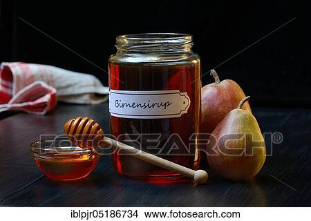 Picture - Pear syrup in glass jar and bowl. Fotosearch