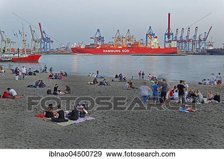 People having a picnic, Elbstrand in front of container port Hamburg Süd, evening mood, at Övelgönne, Hamburg, Germany, Europe View Large Photo Image Stock Photo - People having a picnic, Elbstrand in front of container port Hamburg Süd, evening mood, at Övelgönne, Hamburg, Germany, Europe. Fotosearch
