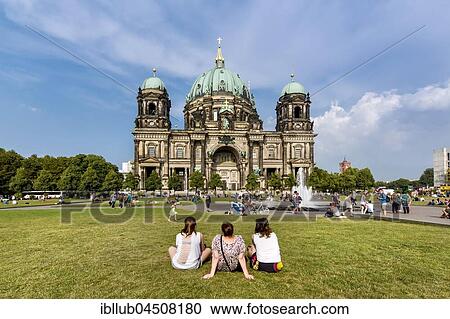 Stock Image - People sitting on lawn in front of the Berlin Cathedral, Museum Island, Berlin-Mitte, Berlin, Germany, Europe. Fotosearch