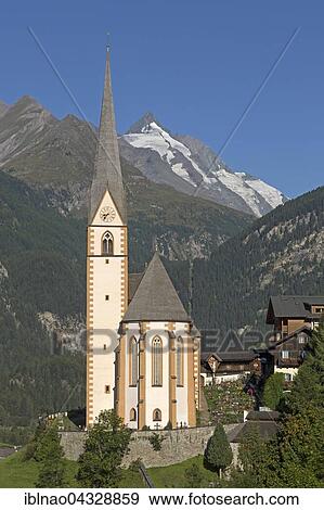 Pilgrimage church St. Vinzenz with Großglockner, Heiligenblut, High Tauern National Park, Carinthia, Austria, Europe View Large Photo Image Stock Photo - Pilgrimage church St. Vinzenz with Großglockner, Heiligenblut, High Tauern National Park, Carinthia, Austria, Europe. Fotosearch