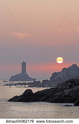 Stock Photograph - Pointe du Raz with lighthouse at sunset, Sizun, Brittany, France, Europe. Fotosearch