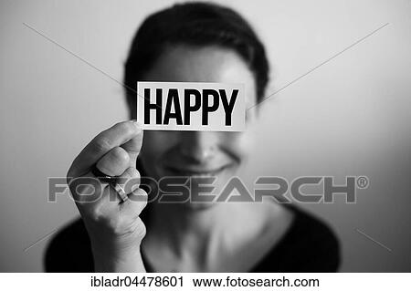Portrait of a laughing woman holding a card with inscription Happy View Large Photo Image Stock Image - Portrait of a laughing woman holding a card with inscription Happy. Fotosearch