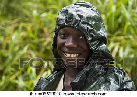 Pretty girl wearing a raincape smiling, Sao Tome, Sao Tome and Principe, Atlantic ocean, Africa View Large Photo Image Stock Photo - Pretty girl wearing a raincape smiling, Sao Tome, Sao Tome and Principe, Atlantic ocean, Africa. Fotosearch