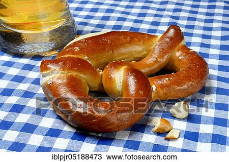 Stock Image - Pretzel, pretzel and glass of beer, pretzel pastry. Fotosearch