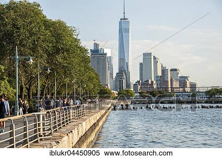 Stock Photography - Promenade along Hudson River with view onto Lower Manhattan skyline, One World Trade Center, Manhattan, New York City, United States, North America. Fotosearch
