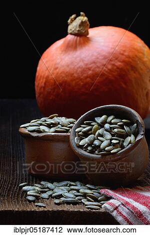 Stock Image - Pumpkinseeds ( Cucurbita) in ceramic pots spec. Fotosearch