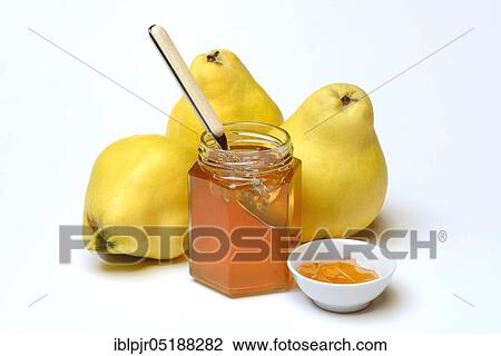 Stock Image - Quince jelly in glass with spoon, quince, Cydonia oblonga. Fotosearch