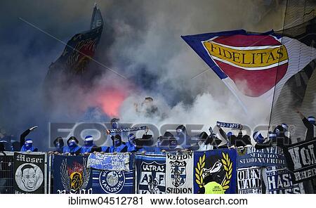 Radical fans at soccer match, hooded hooligans with Bengal light, pyrotechnics, fan section KSC Karlsruher SC, Merdedes-Benz-Arena, Stuttgart, Baden-Württemberg, Deutschland View Large Photo Image Stock Image - Radical fans at soccer match, hooded hooligans with Bengal light, pyrotechnics, fan section KSC Karlsruher SC, Merdedes-Benz-Arena, Stuttgart, Baden-Württemberg, Deutschland. Fotosearch