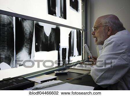 Stock Image - Radiologist evaluates x-ray photographs, dictates reports, Altona Children's Hospital, Hamburg, Germany, Europe. Fotosearch