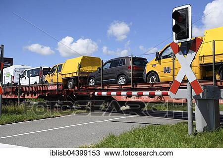 Stock Image - Railroad crossing, car train, Sylt Shuttle, connecting the island of Sylt with the mainland, Sylt, North Frisian Islands, North Frisia, Schleswig-Holstein, Germany, Europe. Fotosearch