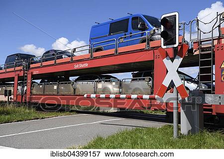 Stock Photo - Railroad crossing, car train, Sylt Shuttle, connecting the island of Sylt with the mainland, Sylt, North Frisian Islands, North Frisia, Schleswig-Holstein, Germany, Europe. Fotosearch