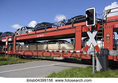 Stock Photograph - Railroad crossing, car train, Sylt Shuttle, connecting the island of Sylt with the mainland, Sylt, North Frisian Islands, North Frisia, Schleswig-Holstein, Germany, Europe. Fotosearch