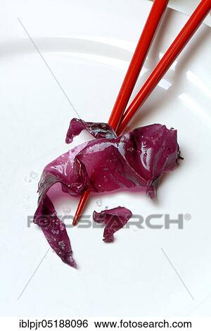 Stock Photograph - Red algae with sea salt and chopsticks, seaweed, Rhodymenia palmata. Fotosearch