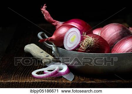 Stock Image - Red onions with onion rings in skin, Allium cepa. Fotosearch