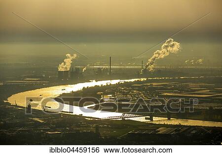 Rheinschleife in evening light between Rheinhausen and Angerhausen, steaming chimneys against backlight, HKM Hüttenwerke Krupp Mannesmann, Duisburg, Ruhr district, North Rhine-Westphalia, Germany, Europe View Large Photo Image Stock Photograph - Rheinschleife in evening light between Rheinhausen and Angerhausen, steaming chimneys against backlight, HKM Hüttenwerke Krupp Mannesmann, Duisburg, Ruhr district, North Rhine-Westphalia, Germany, Europe. Fotosearch