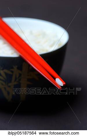 Picture - Rice grain on chopsticks, basmati rice, Oryza sativa, cooked. Fotosearch