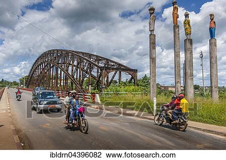 Stock Image - Road next to the old bridge, former railway bridge over the river Sanaga from the German colonial era, Edéa, Littoral Region, Cameroon, Africa. Fotosearch