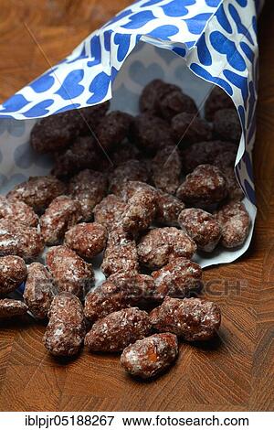 Stock Photo - Roasted almonds in bag, paper bag. Fotosearch