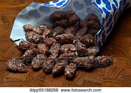 Stock Photo - Roasted almonds in bag, paper bag. Fotosearch