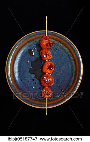 Roasted cherry tomatoes on skewer on plate, Solanum lycopersicum View Large Photo Image Stock Photo - Roasted cherry tomatoes on skewer on plate, Solanum lycopersicum. Fotosearch