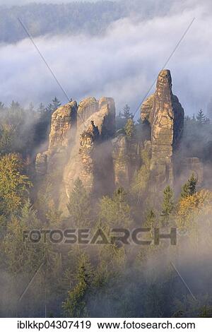 Rock serrated crown, Viererturm and Schramm gatekeepers in morning mist, Autumn, Elbe Sandstone Mountains, Saxon Switzerland, Saxony, Germany, Europe View Large Photo Image Stock Photo - Rock serrated crown, Viererturm and Schramm gatekeepers in morning mist, Autumn, Elbe Sandstone Mountains, Saxon Switzerland, Saxony, Germany, Europe. Fotosearch