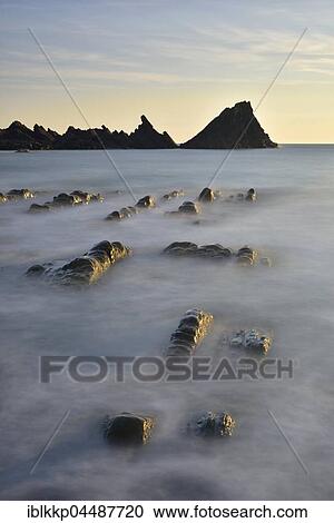 Stock Image - Rocks in the sea, rocky coast, Atlantic Coast, Hartland Quay, Devon, United Kingdom, Europe. Fotosearch