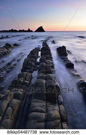 Rocks in the sea, rocky coast in the evening light, Atlantic Coast, Hartland Quay, Devon, United Kingdom, Europe View Large Photo Image Stock Photo - Rocks in the sea, rocky coast in the evening light, Atlantic Coast, Hartland Quay, Devon, United Kingdom, Europe. Fotosearch